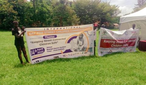 Some rehabilitated street children holding banner in Jinja city 
