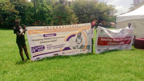 Some rehabilitated street children holding banner in Jinja city 